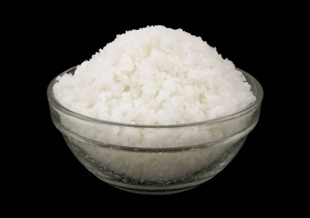 istock Glass bowl with salt isolated on black 1437423030