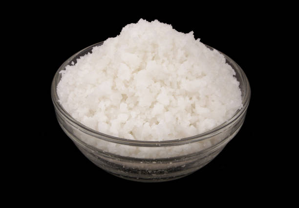istock Glass bowl with salt isolated on black 1437423033