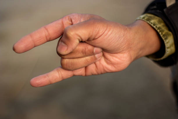 istock Showing two fingers like devil horns and the background blur 1437423887