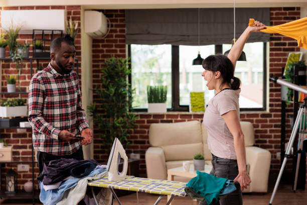 istock Multiracial couple arguing in living room 1437424210