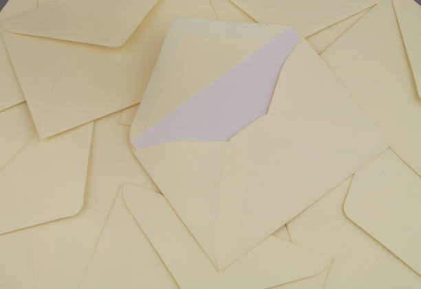 istock Many yellow mail envelopes close up. One envelope with letter. 1437425444