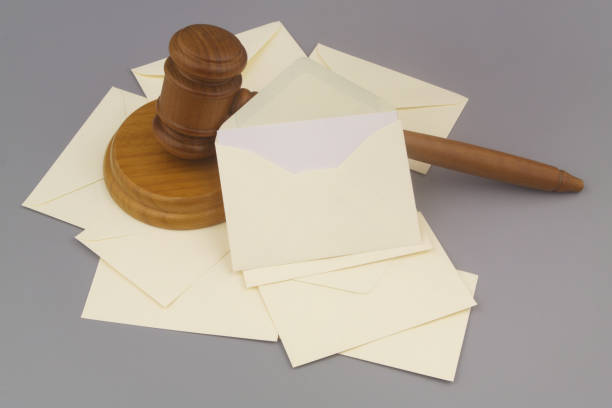 istock Mail envelopes and wooden judge gavel on gray background. 1437425515