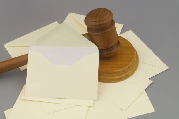 istock Mail envelopes and wooden judge gavel on gray background. 1437425521