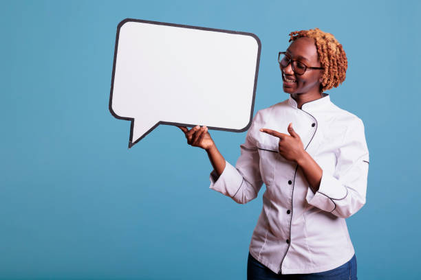 istock Female cook pointing to empty white dialogue bubble 1437425552
