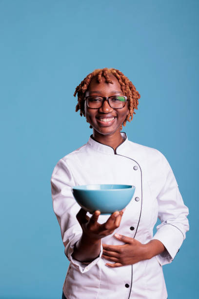 istock Happy cooker showing a container, looking at the camera 1437426460