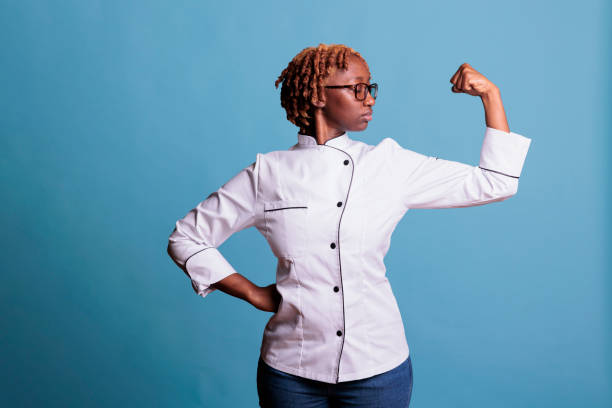istock Female cook flexing arm with pose of power 1437426695
