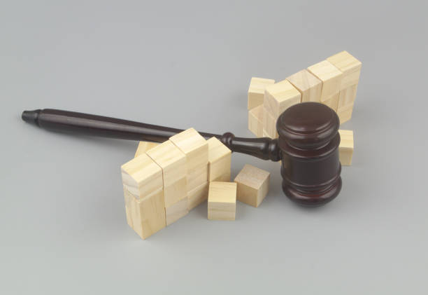 istock Wooden gavel breaking wall. 1437430364