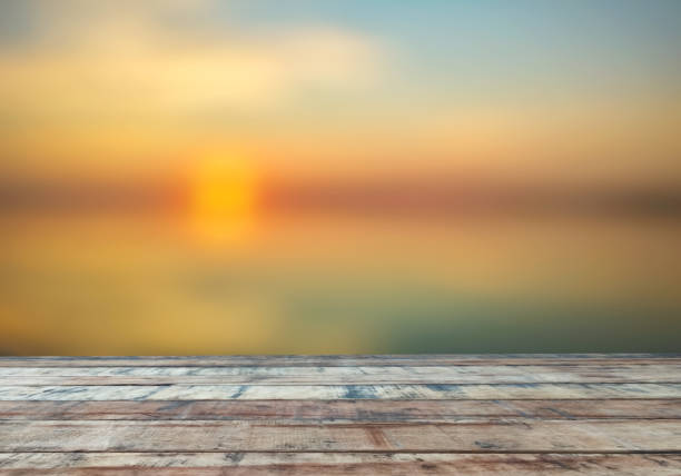 istock old brown wooden table  Sea Sunset Blur Background Template Design Display Advertising 1437431915