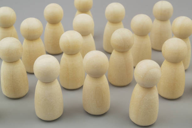 istock Many wooden people figures on gray background 1437435637