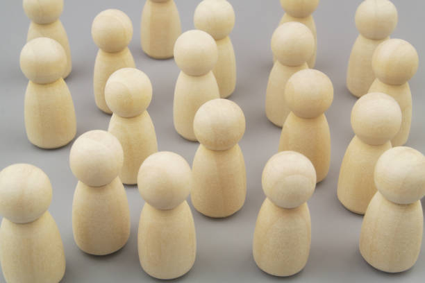 istock Many wooden people figures on gray background 1437435661