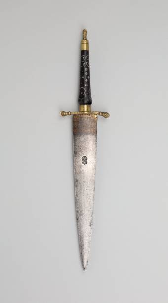 istock Vertical shot of a medieval dagger isolated on a gray background 1437436699