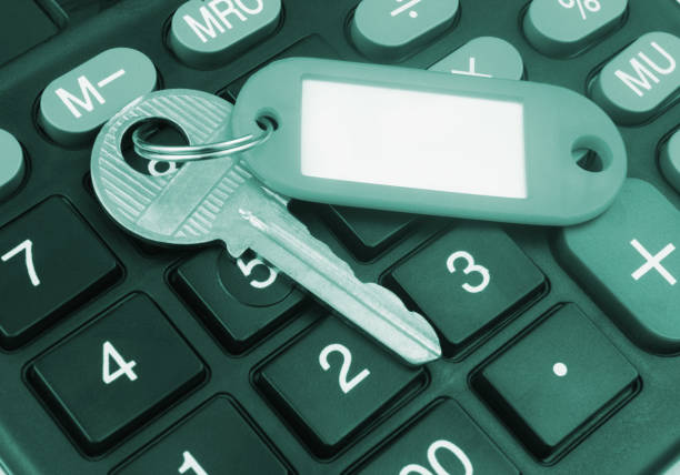 istock Key with red label and calculator. 1437437425