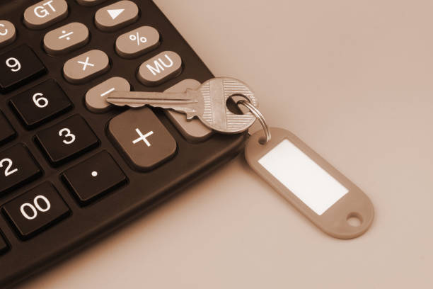 istock Key with red label and calculator on gray background. 1437437503