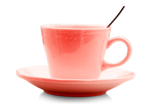 Color ceramic cup with spoon isolated on white background