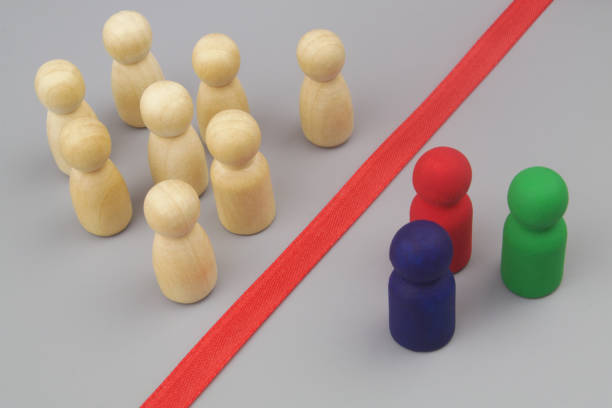 istock Colored and common wooden figures separated by red line. 1437439032
