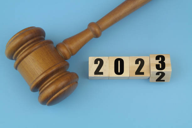 Wooden judge gavel and numbers 2023 and 2023 on wooden cubes. stock photo
