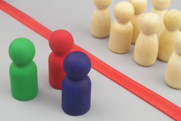 istock Colored and common wooden figures separated by red line. 1437439065