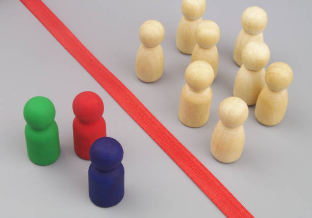 istock Colored and common wooden figures separated by red line. 1437439707