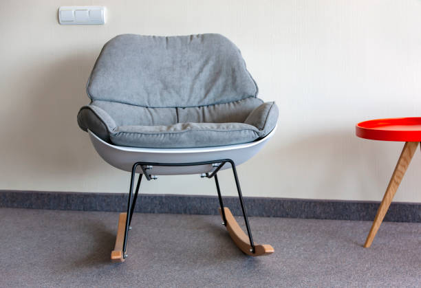istock rocking chair and table against the wall. Interior inside. Selective focus 1437439909