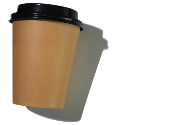 istock Cardboard coffee cup with plastic lid with hard shadow on white background. isolated object. Template with copy space. The concept of ecology, recycling, environmental protection. 1437440193