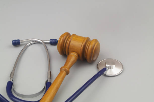 Judge gavel and stethoscope on gray background close up. stock photo