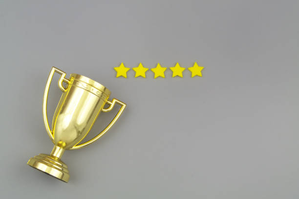 istock Gold champion trophy cup with five stars on gray background. 1437440415
