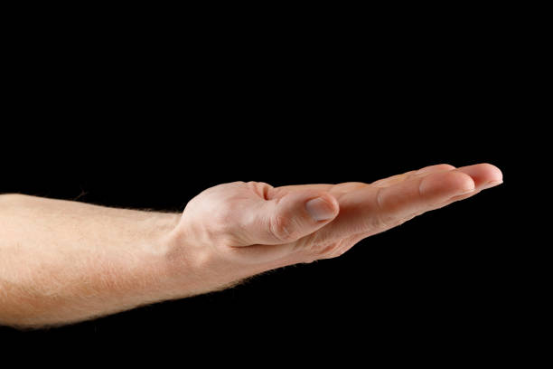 istock Hand and open palm on black isolate. Caucasian male hand. 1437442677