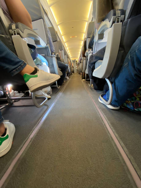 istock Interior of airplane with passengers on seats while flying. Travel concept,selective focus 1437443403