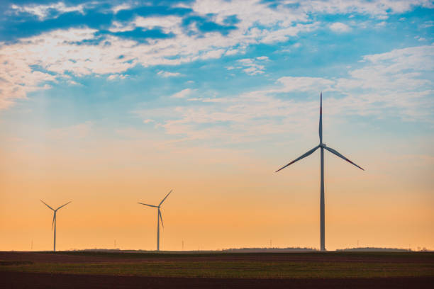 istock Horizontal axis wind turbines in the field at dusk 1437443591