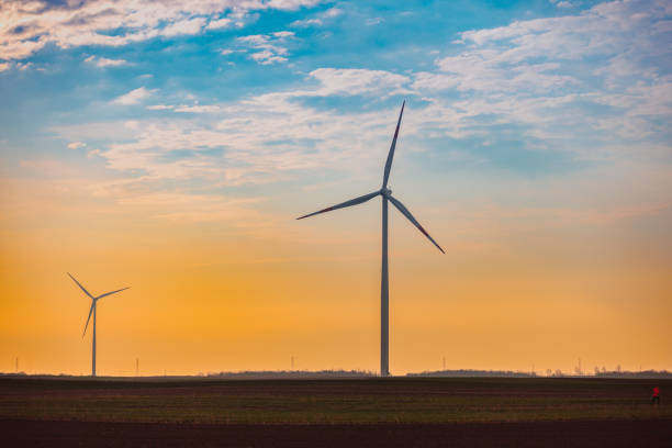 istock Horizontal axis wind turbines in the field at sunset 1437443625