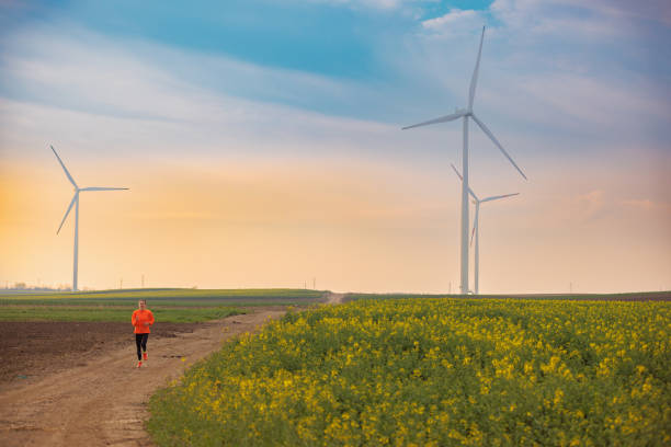 istock Running on dirt road in wind farm 1437443627