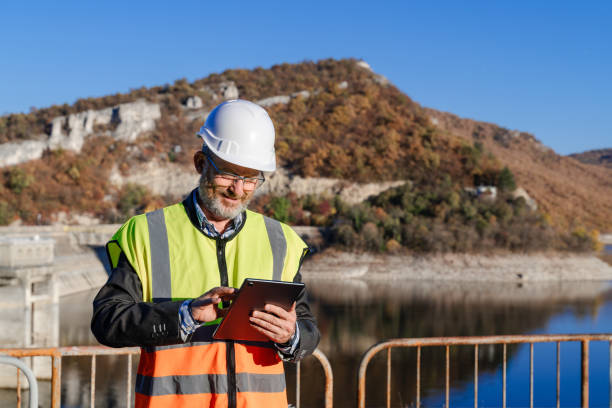 istock Mature male engineer working with a digital tablet in the hydroelectric dam 1437444597