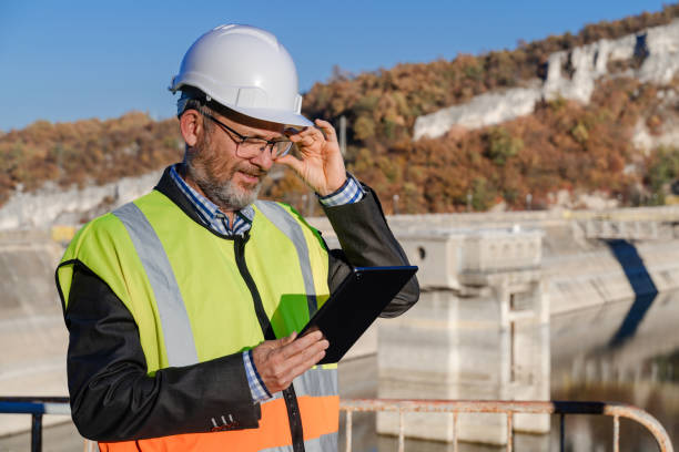 istock Mature male engineer working with a digital tablet in the hydroelectric dam 1437444634