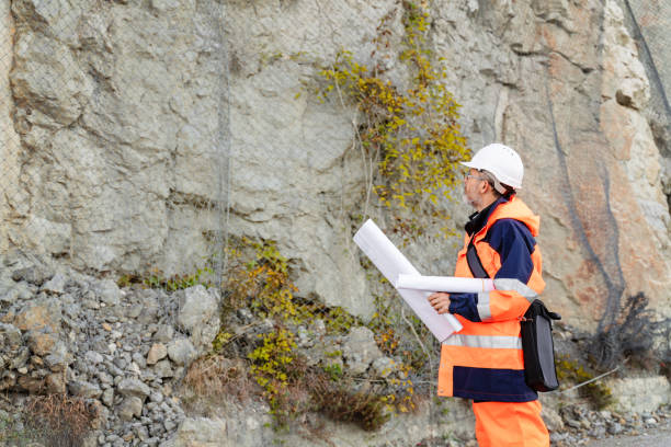istock Mature male road construction engineer looking at blueprints 1437444743