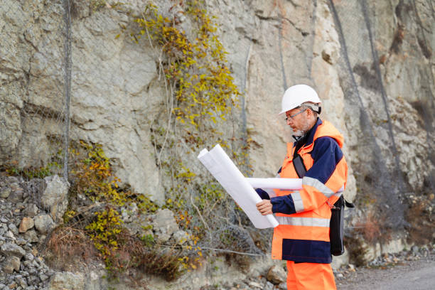 istock Mature male road construction engineer looking at blueprints 1437444747
