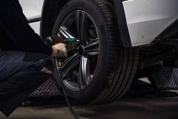 istock SUV on the car lift in auto service, Master taking off the wheels 1437445263