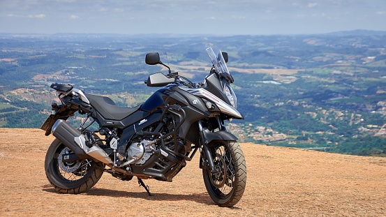 Campinas, Brazil – July 29, 2022: cruiser motorcycle on mountain with village background