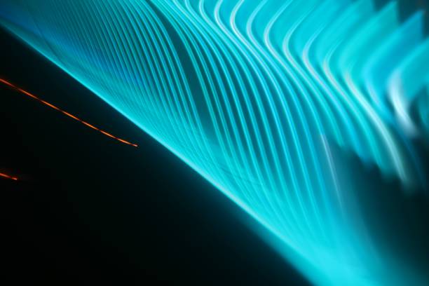 istock Horizontal shot of intersecting refracted blue light layers on a black background 1437449937