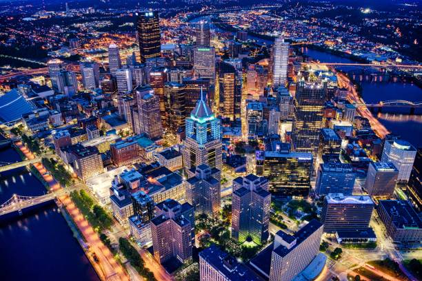 Aerial shot of the night Pittsburgh cityscape in Pennsylvania An aerial shot of the night Pittsburgh cityscape in Pennsylvania downtown pittsburgh pennsylvania stock pictures, royalty-free photos & images