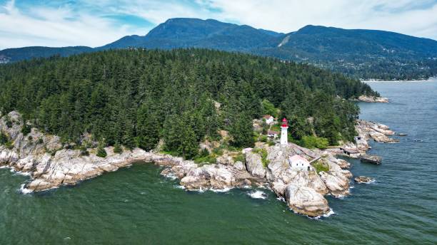 istock View of an old lighthouse on the tree covered seashore 1437451820