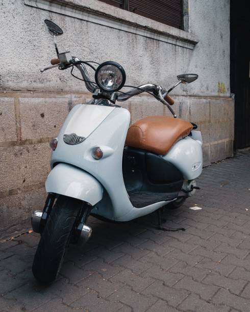 istock Scooter parked on the street against a building 1437451967