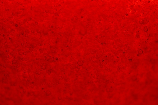 The textural details of a red bubbly liquid-perfect for backgrounds