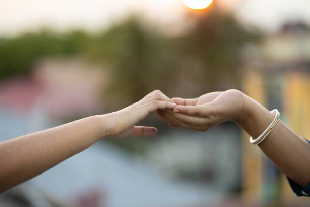 istock Shallow focus shot of two hands touching each other gently 1437452276