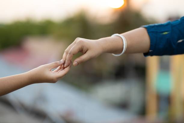 istock Shallow focus shot of two hands touching each other gently 1437452310