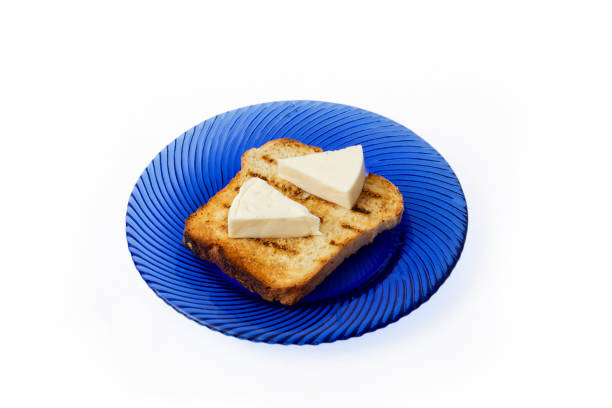 2 cheese triangles on a toasted slice of bread, on a blue glass plate