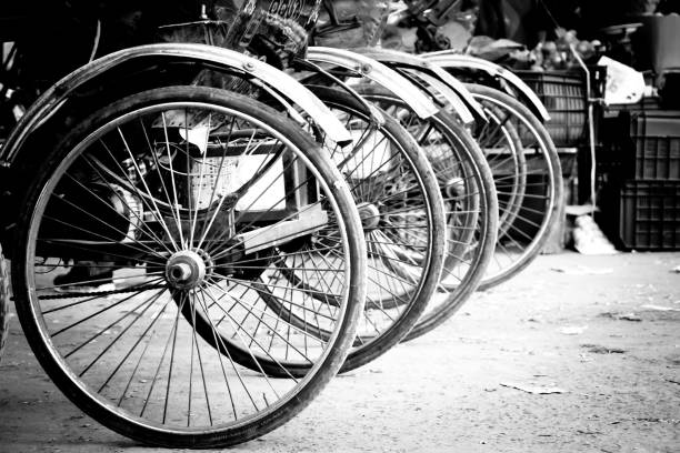 istock Black and white closeup shot of a lined-up bycicles 1437453628