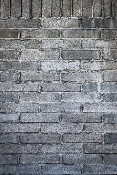 istock Vertical shot of a gray bricked wall with cement 1437454520