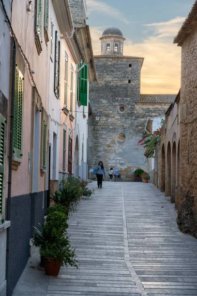 Alcudia, Spain – October 18, 2021: A path surrounded by aged buildings in Alcudia, Mallorca, Spain