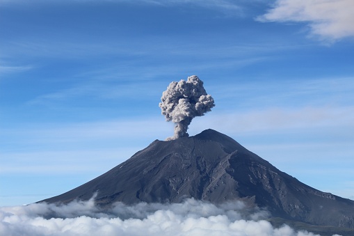 The active Popocatepetl volcano in Mexico against the blue sky