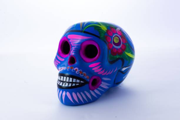 istock Small colorful painted skull isolated on a white background 1437458144